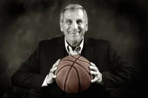 Coach Jim Harrick holding a basketball